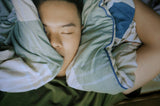 man sleeping enjoying the benefits of using night guards to prevent dental damage