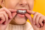 woman using her retainer and enjoying the benefits