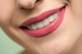 Close-up of a smiling person to emphasize that retainers for teeth help maintain a confident smile