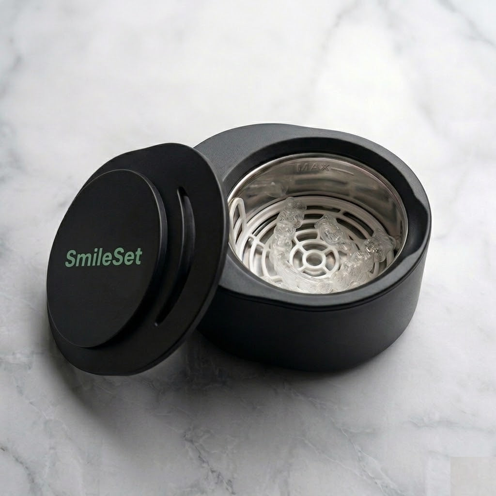 Black SmileSet rechargeable ultrasonic cleaner open to show the basket