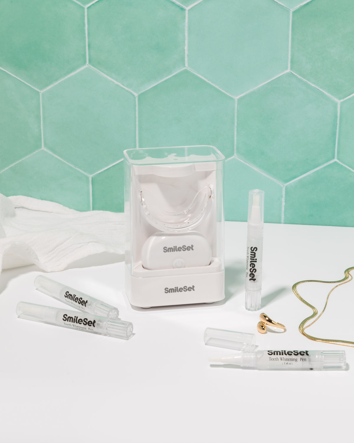 SmileSet whitening kit with LED tray and whitening pens on a bathroom counter
