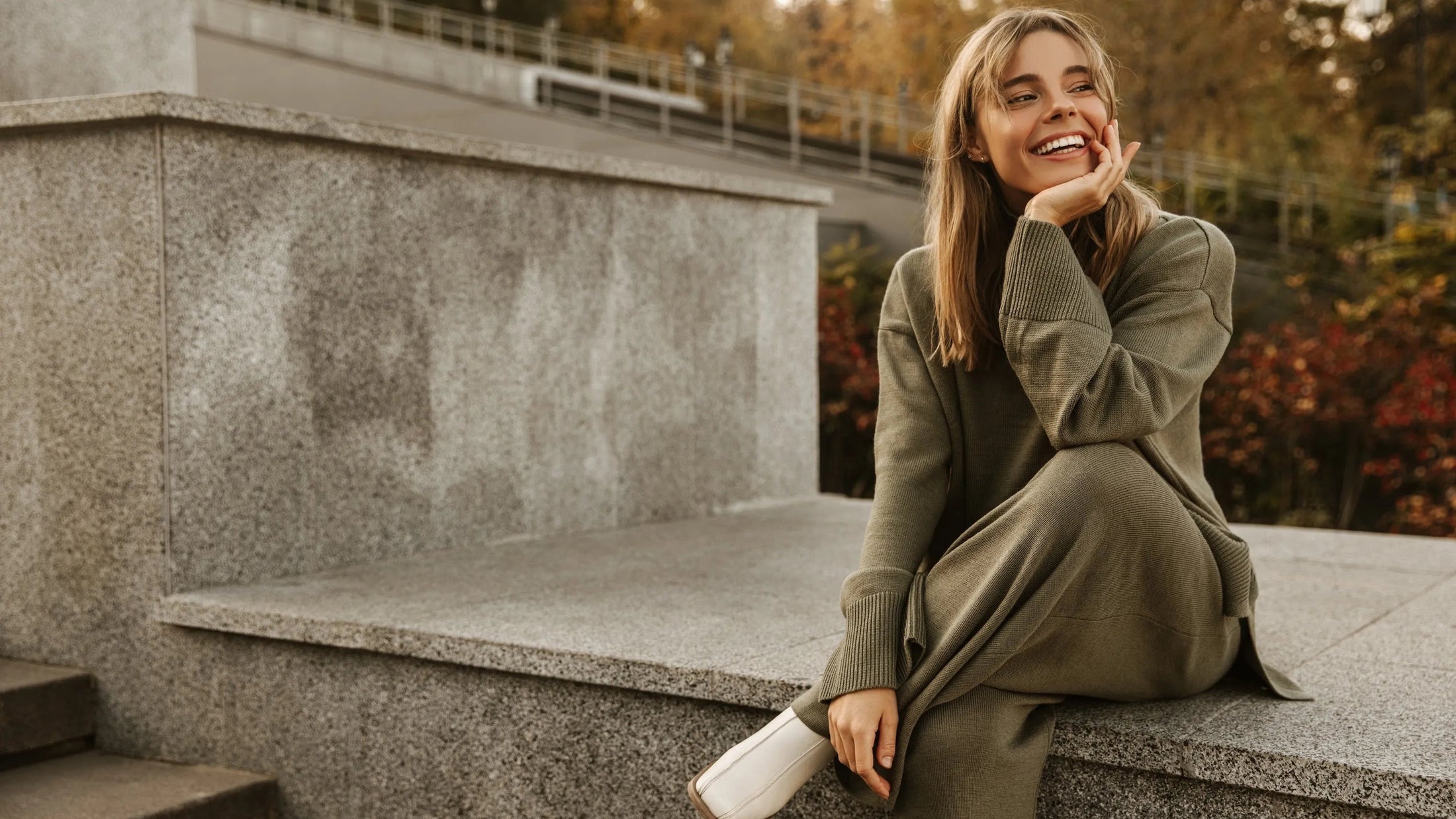 Woman smiling outdoors wearing clear aligners