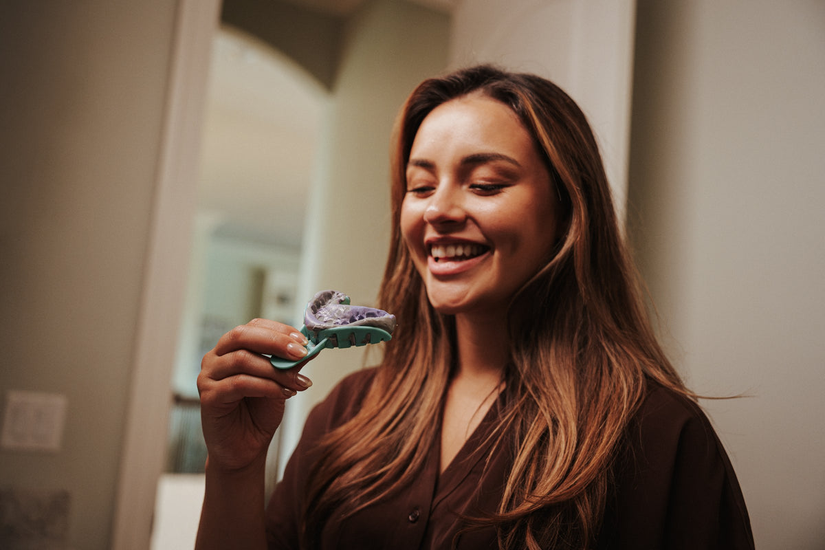 Smiling woman holding a SmileSet impression tray