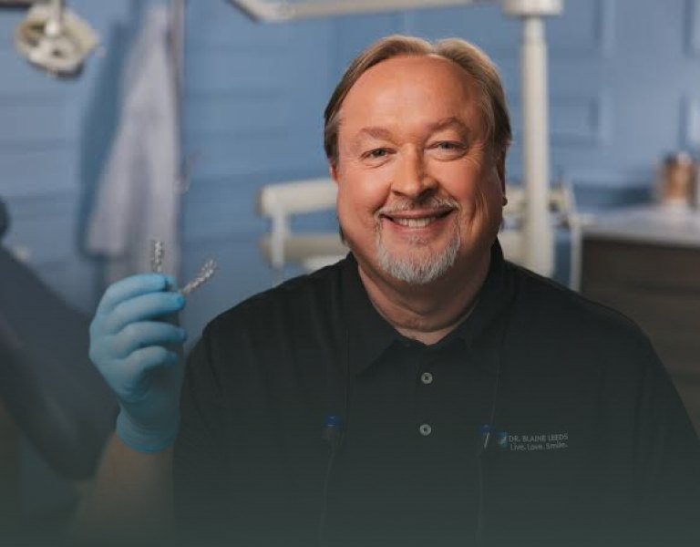 SmileSet doctor holding clear aligners