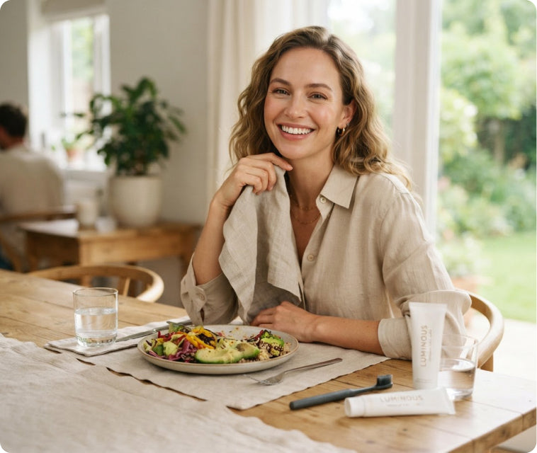 Smiling woman at a table after a meal